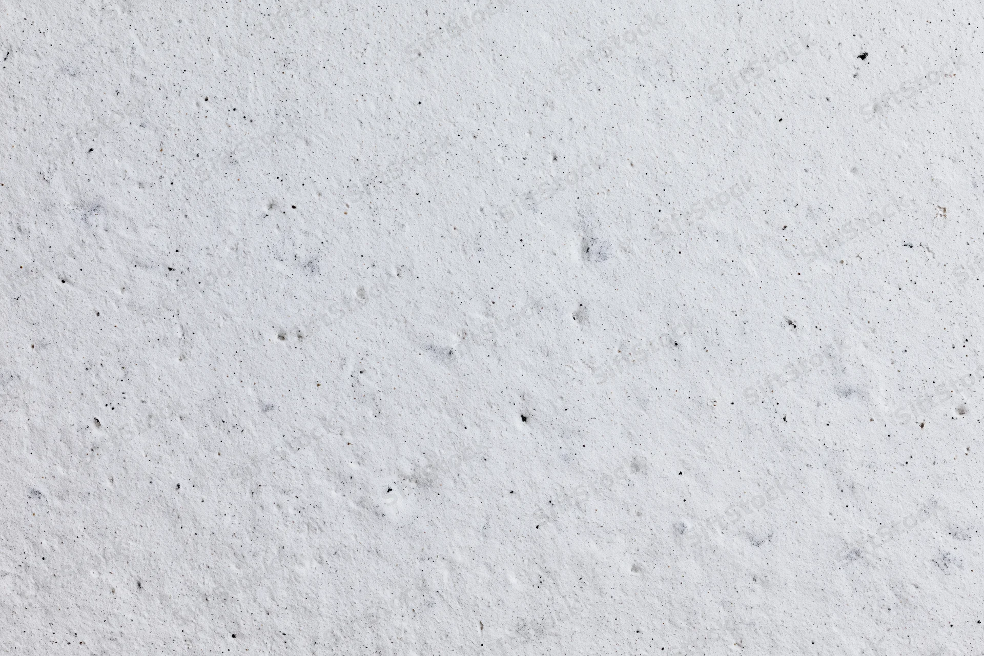 Close-up of a rough white concrete plaster wall surface
