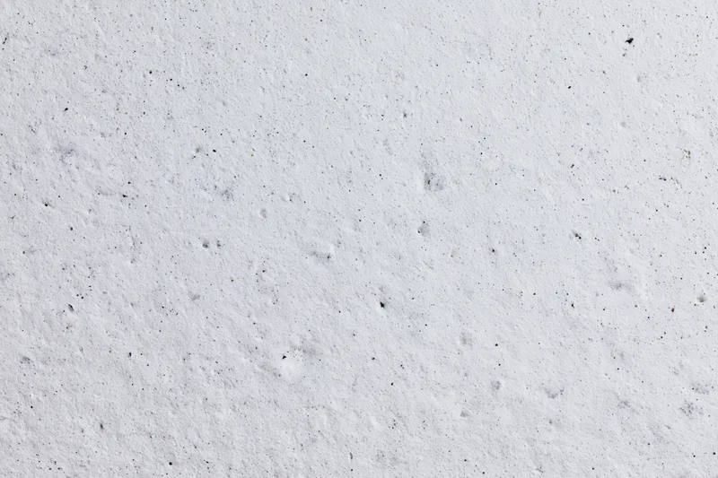 Close-up of a rough white concrete plaster wall surface