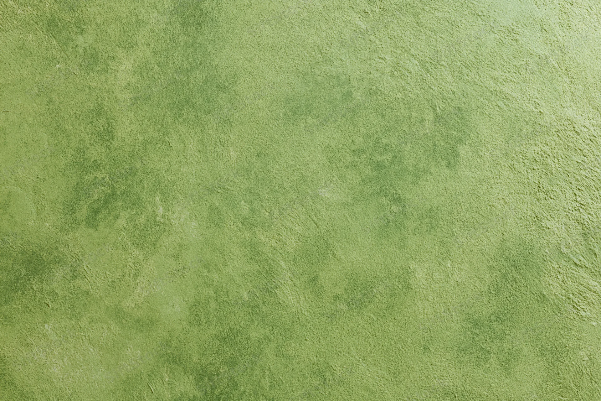 Textured plaster wall surface in green with uneven finish and natural grain