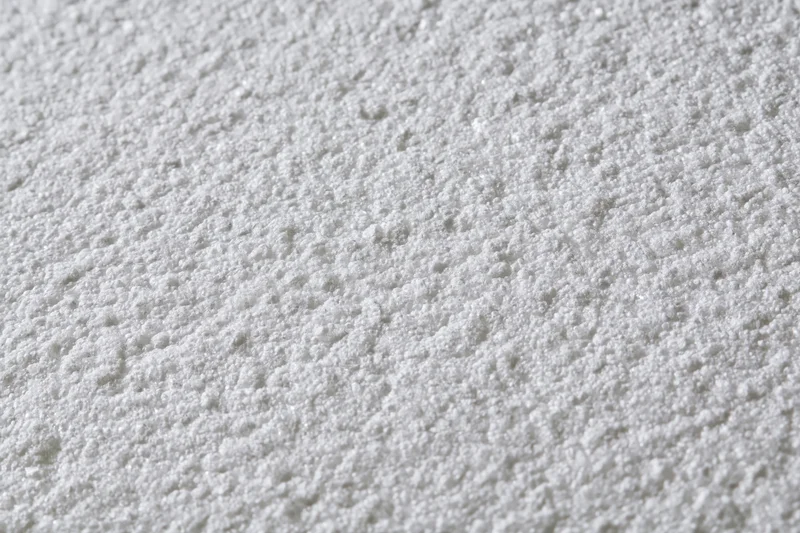 Close-up flat lay of a white expanded polystyrene foam sheet surface
