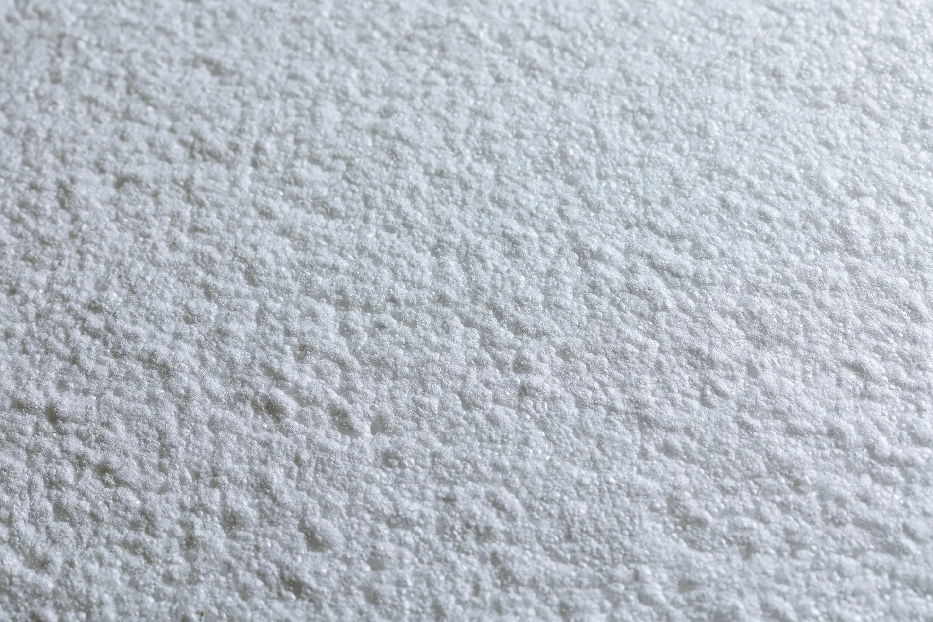 Close-up flat lay of a white expanded polystyrene foam sheet surface