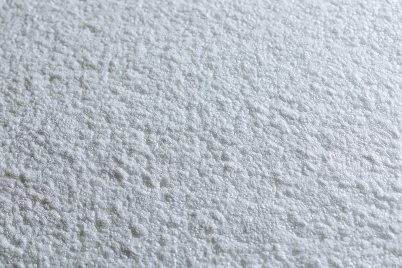 Close-up flat lay of a white expanded polystyrene foam sheet surface