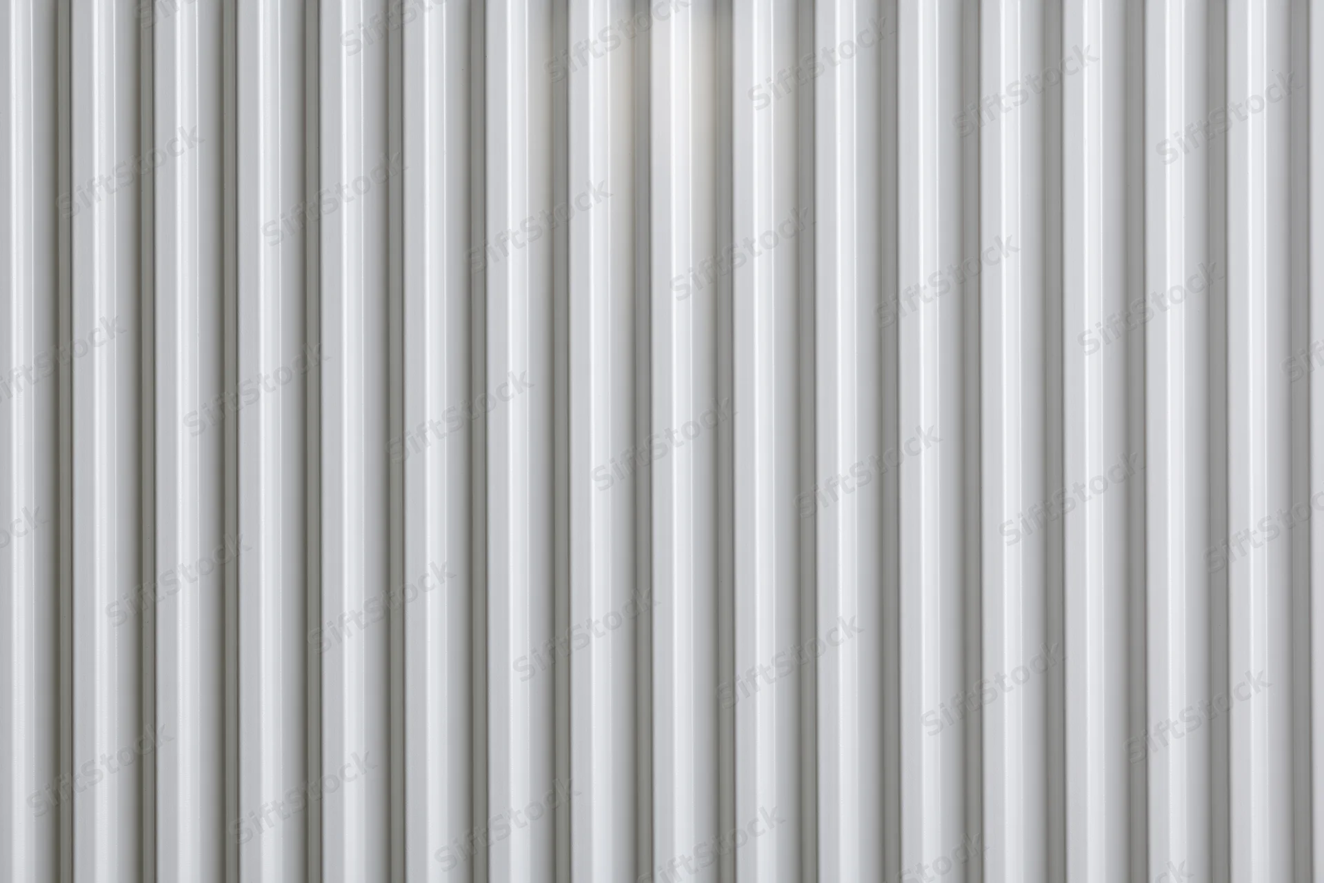 White ribbed panel surface filling the frame in a close-up flat lay view