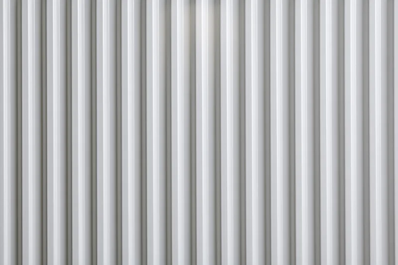 White ribbed panel surface filling the frame in a close-up flat lay view