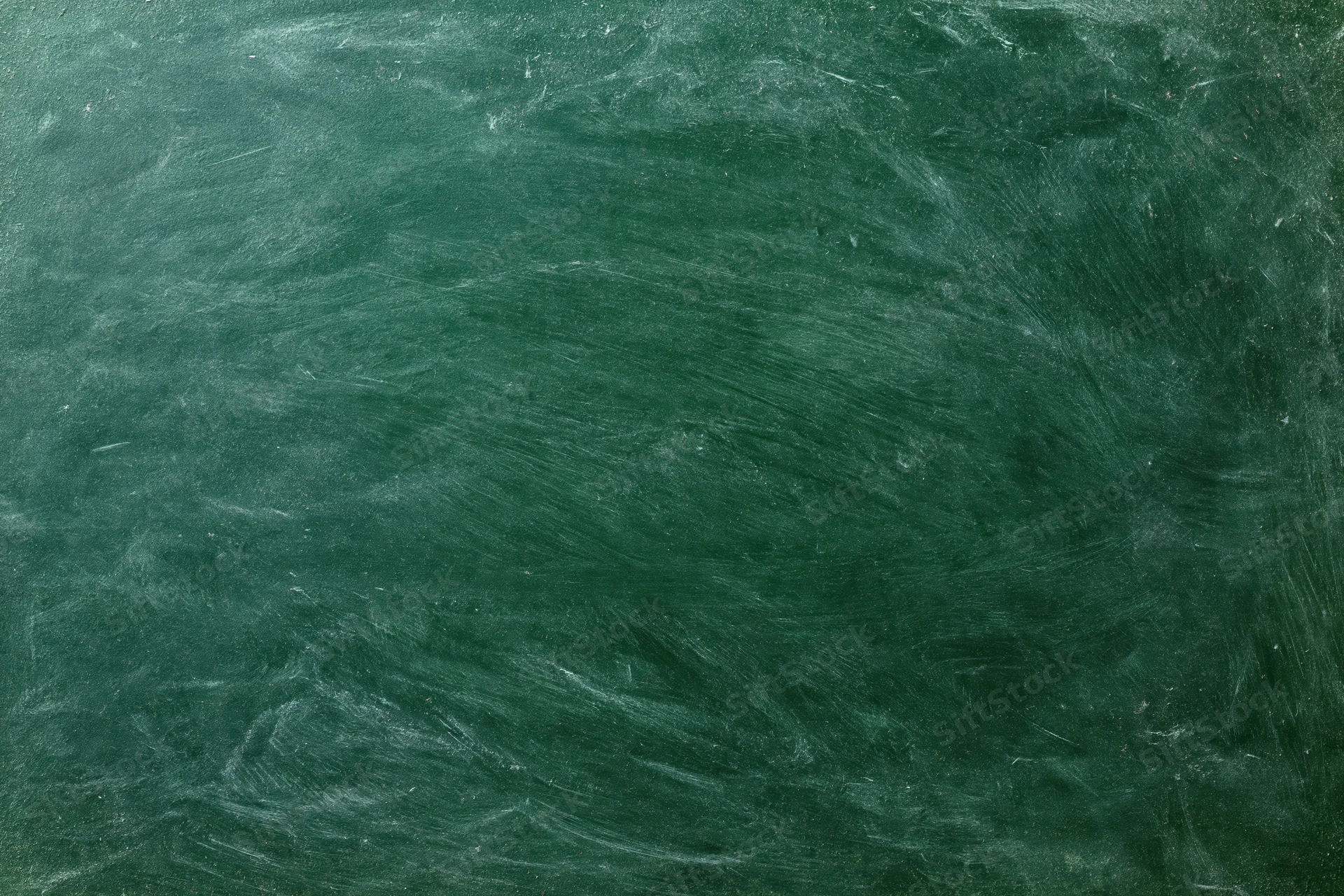 Worn green chalkboard surface with smudged chalk residue filling the frame in a flat lay view