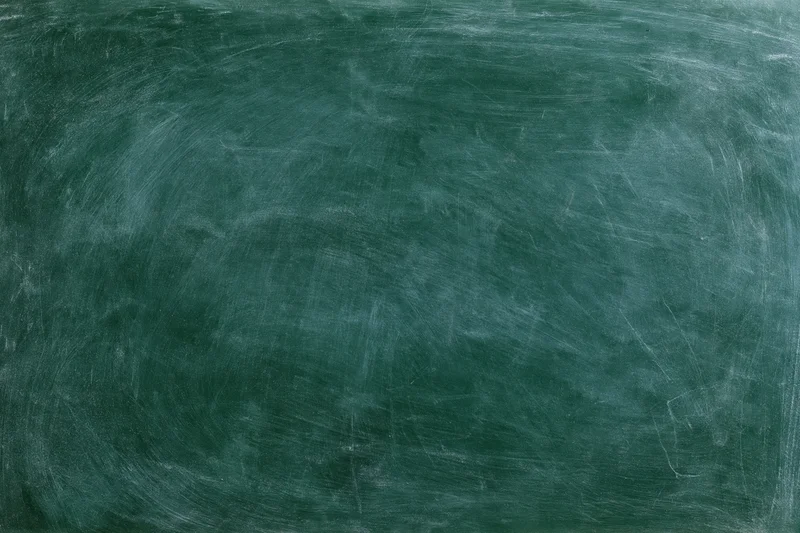 Worn green chalkboard surface with smudged white residue and scratches filling the frame