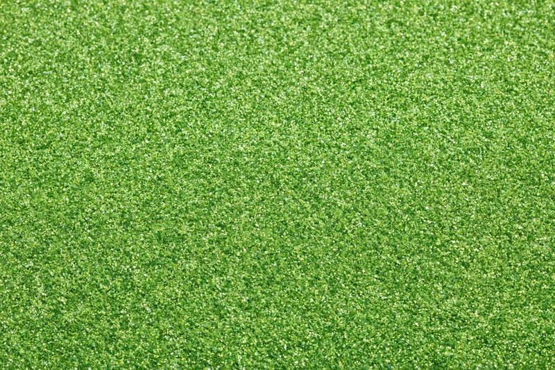 Bright green glitter texture filling the frame in a flat lay arrangement