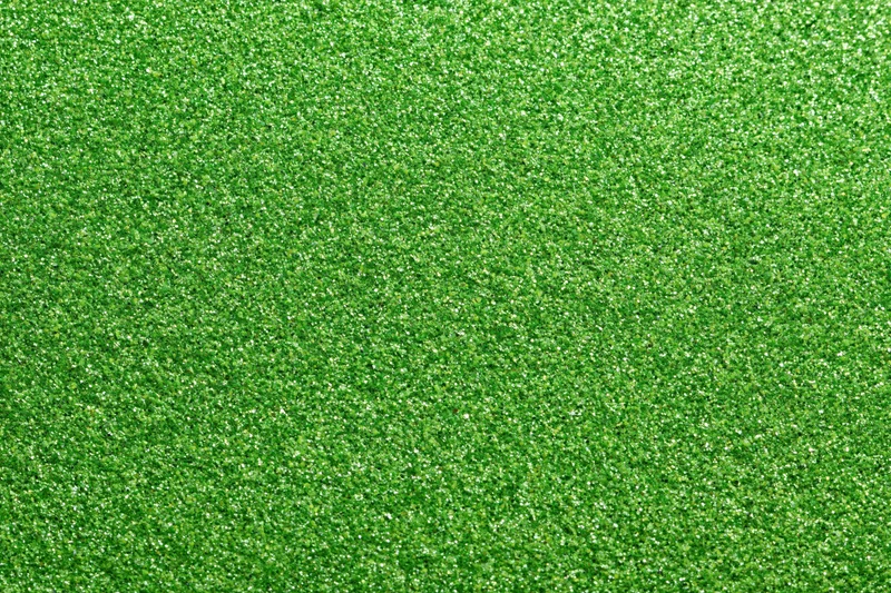 Bright green glitter texture filling the frame in a flat lay close-up view
