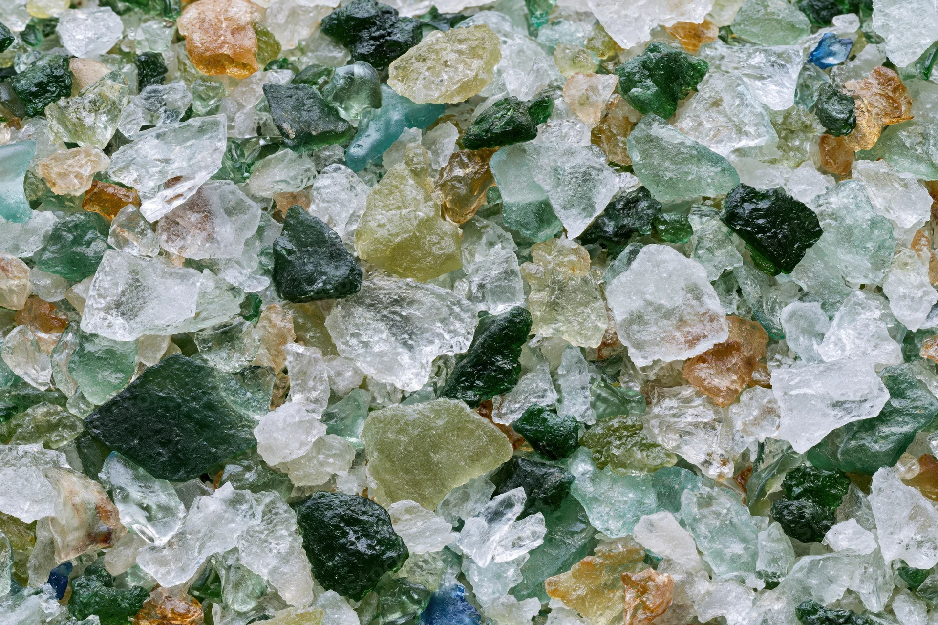 Crushed recycled glass cullet spread flat in a close-up view