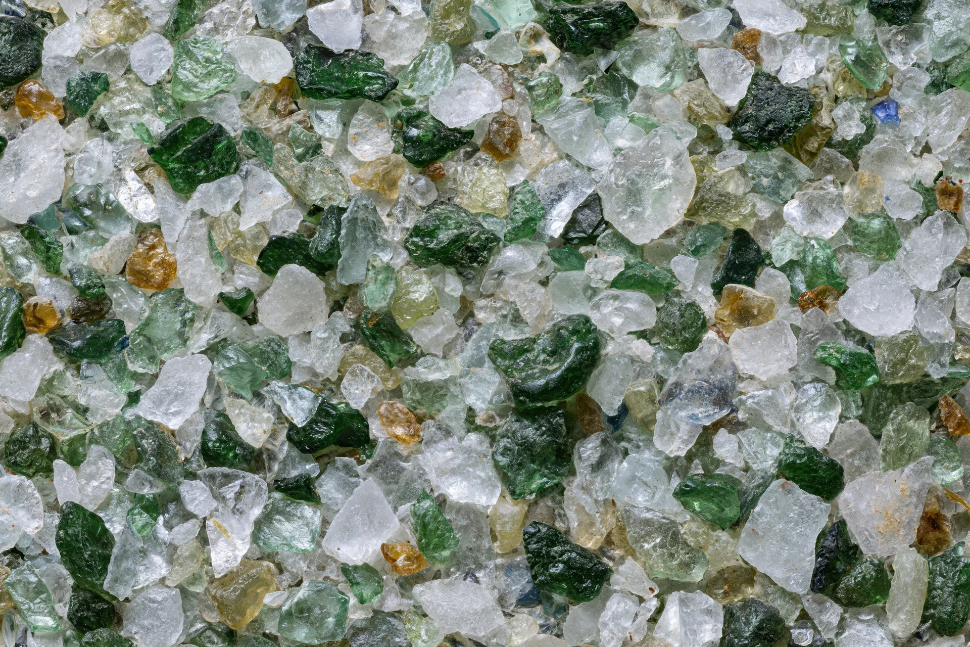 Crushed recycled glass cullet spread flat in a close-up view