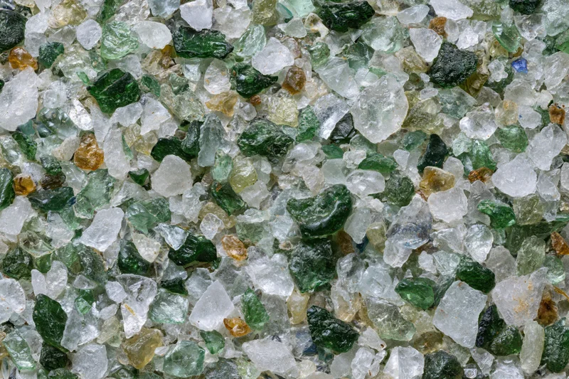 Crushed recycled glass cullet spread flat in a close-up view