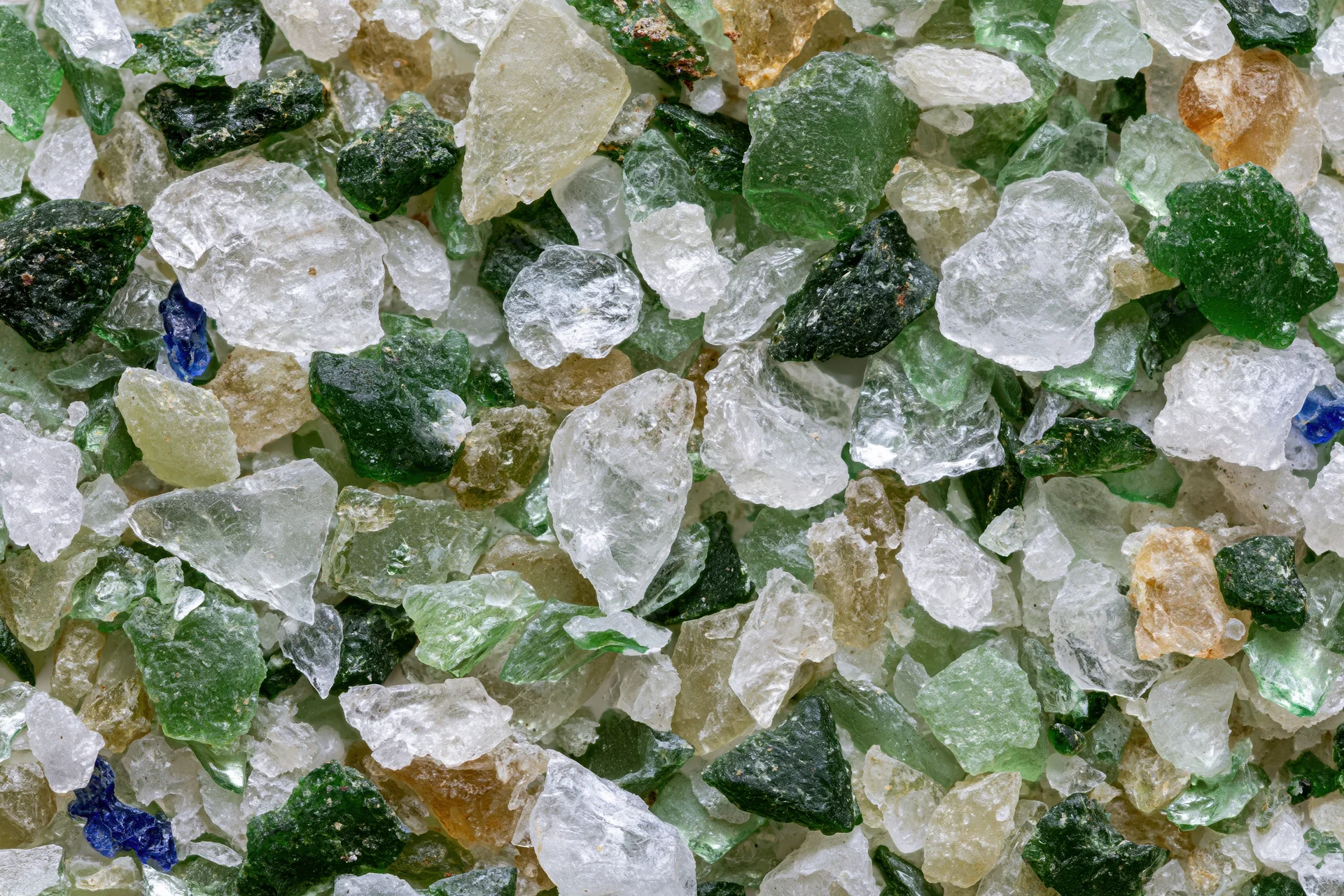 Crushed recycled glass cullet spread flat in a close-up view