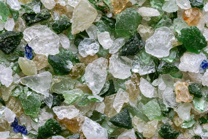 Crushed recycled glass cullet spread flat in a close-up view