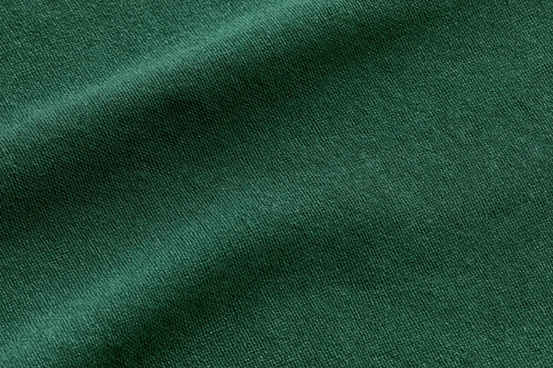 Dark forest green fabric textile filling flat lay close-up