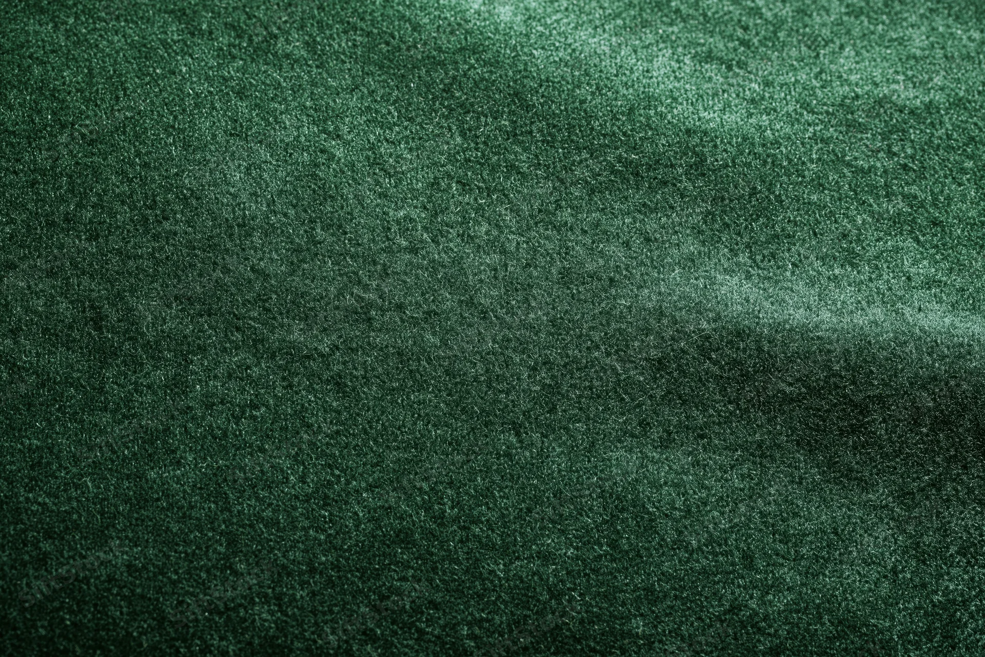 Dark green velvet fabric in flat lay closeup filling the frame