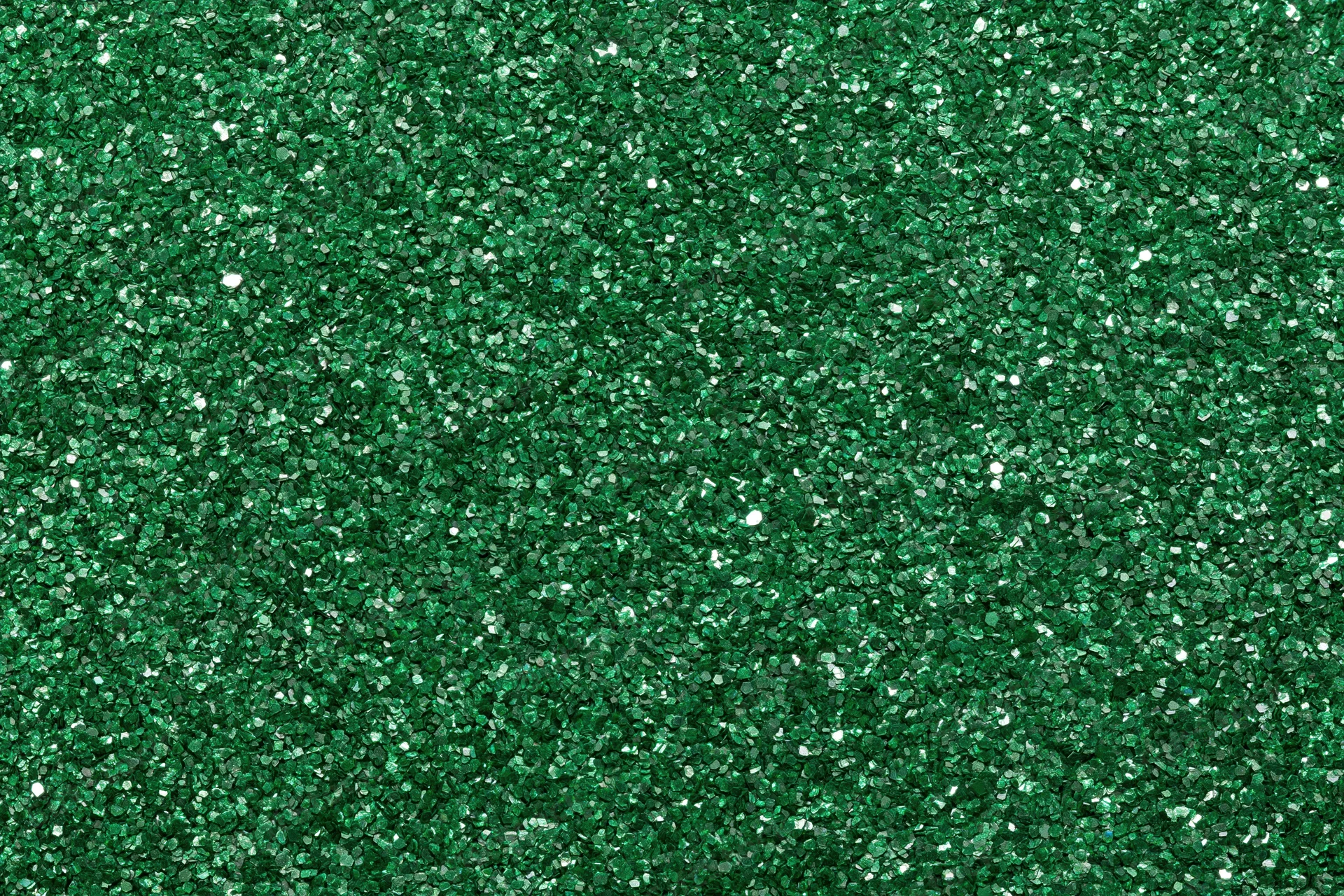 Dense green glitter filling the frame in a flat lay close-up view