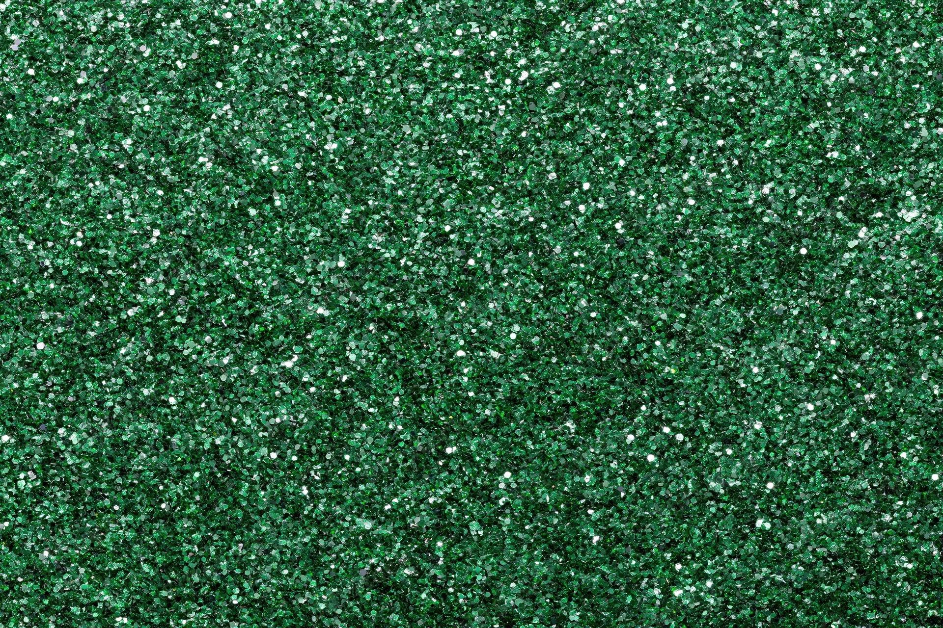 Dense green glitter filling the frame in a flat lay close-up view