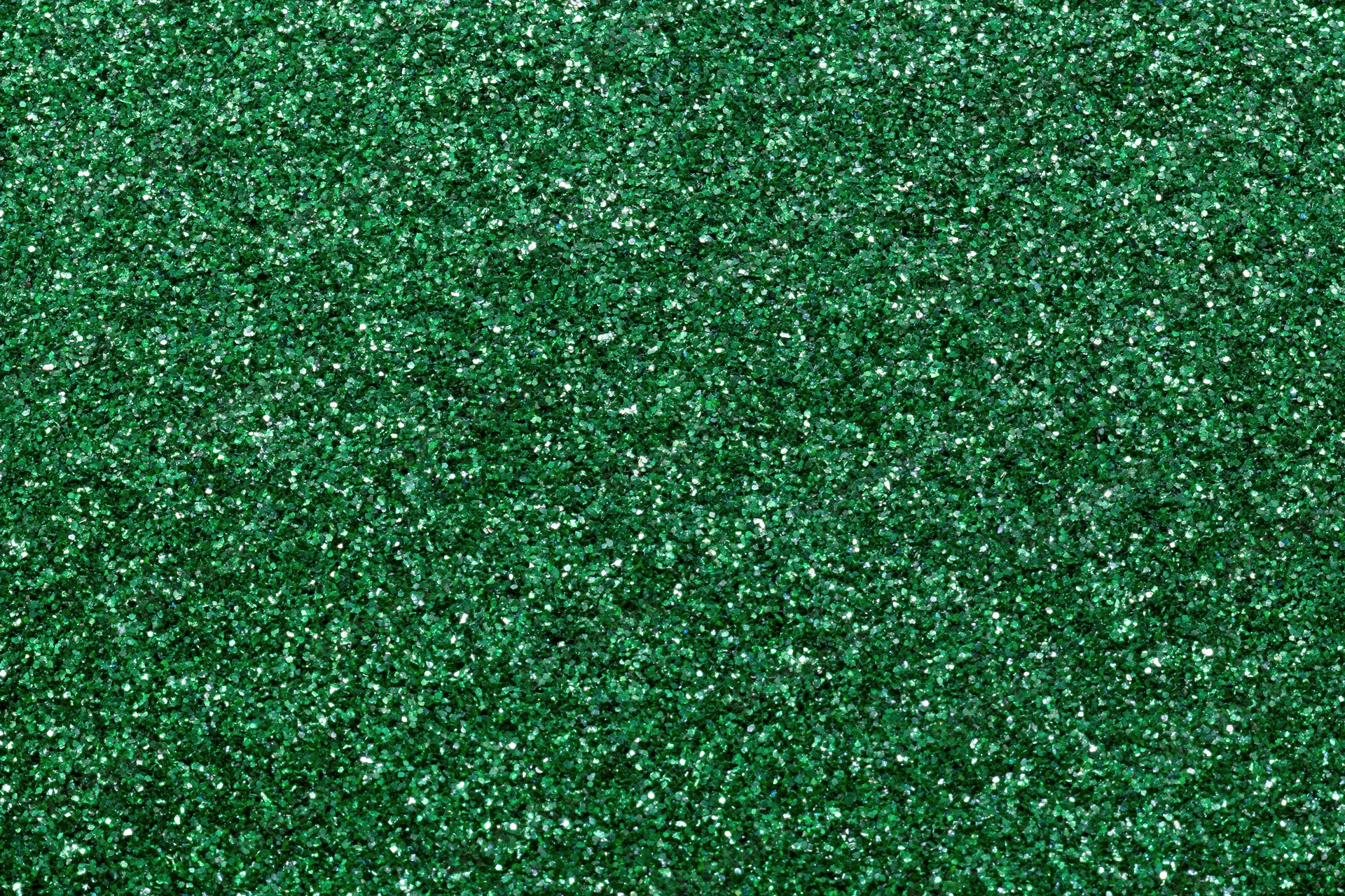 Dense green glitter filling the frame in a flat lay close-up view
