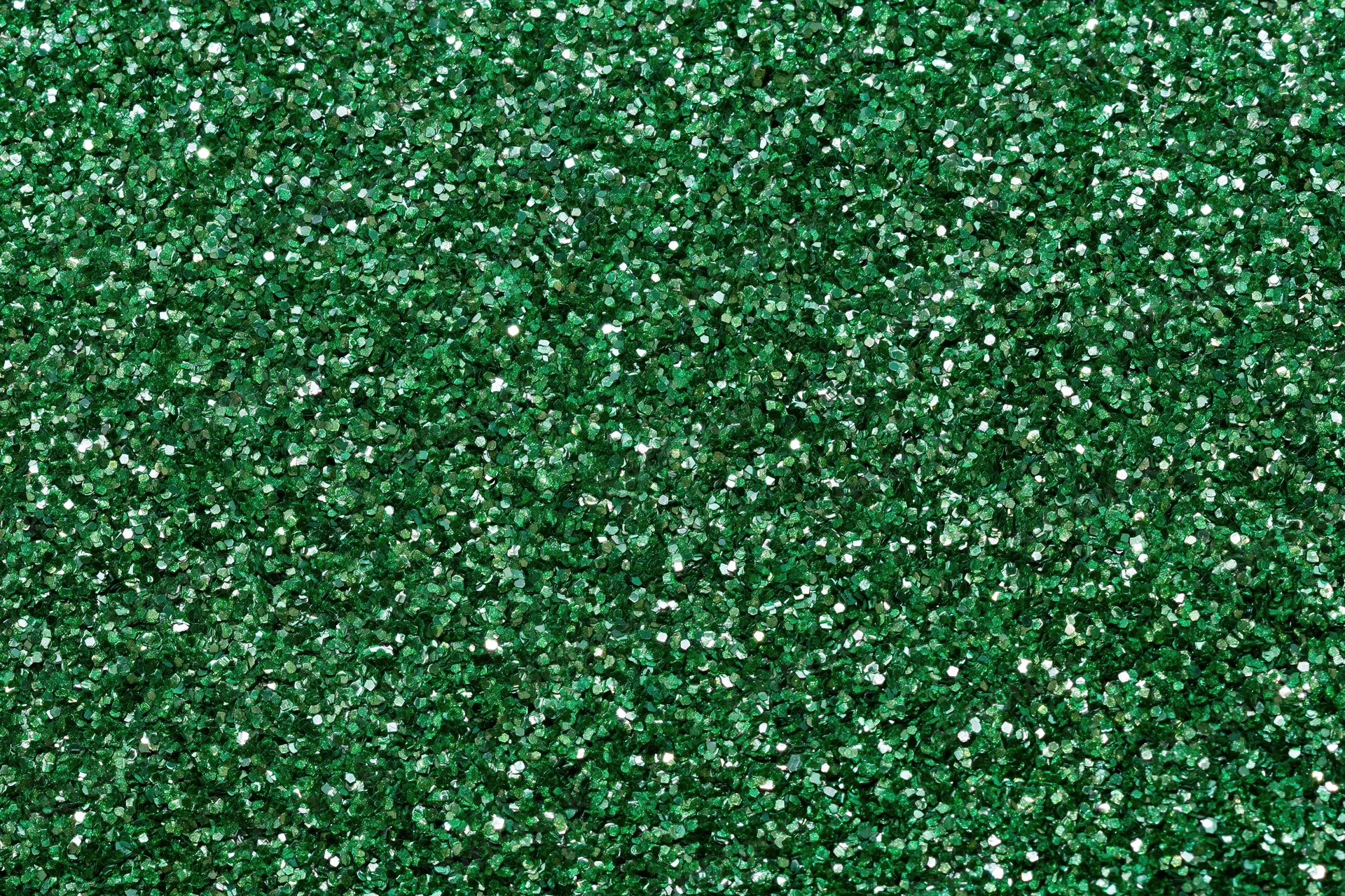 Dense green glitter filling the frame in a flat lay closeup