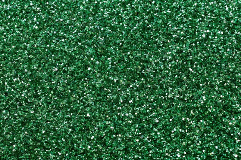 Dense green glitter filling the frame in a flat lay closeup