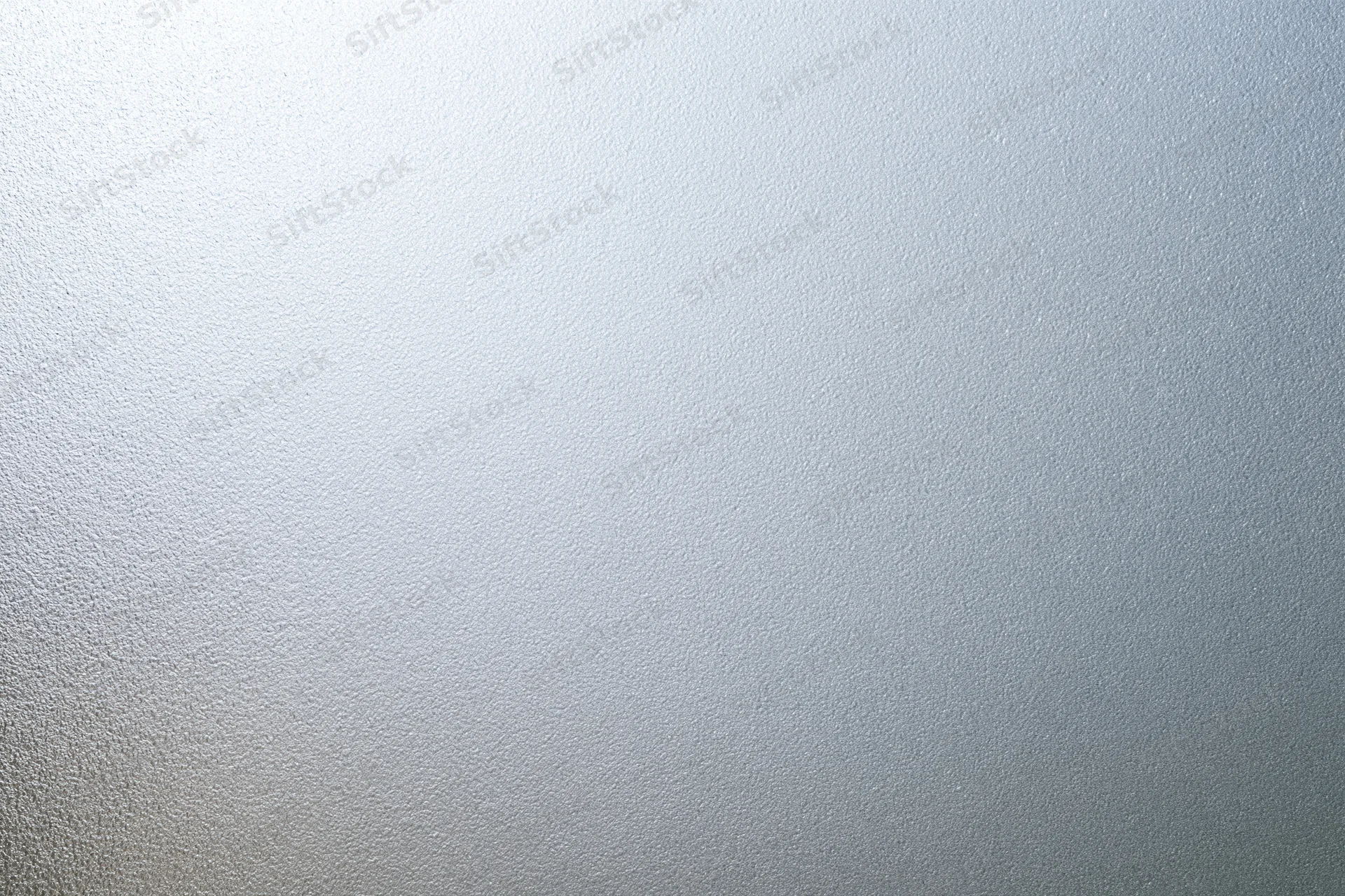 Frosted glass surface with smooth matte texture filling the frame in a flat lay closeup