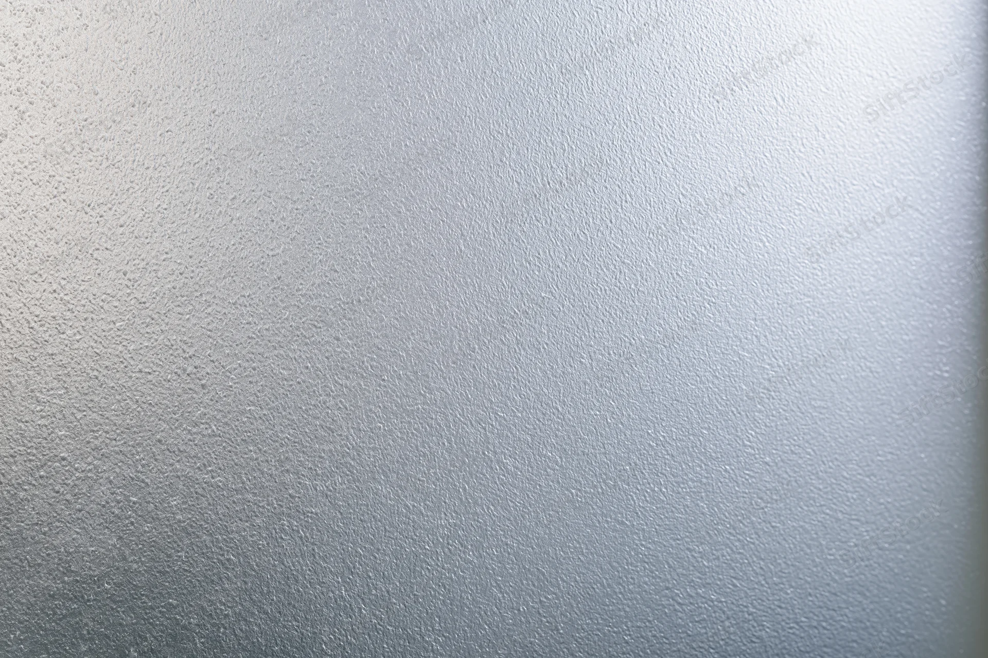 Frosted glass surface with smooth matte texture filling the frame in a flat lay view