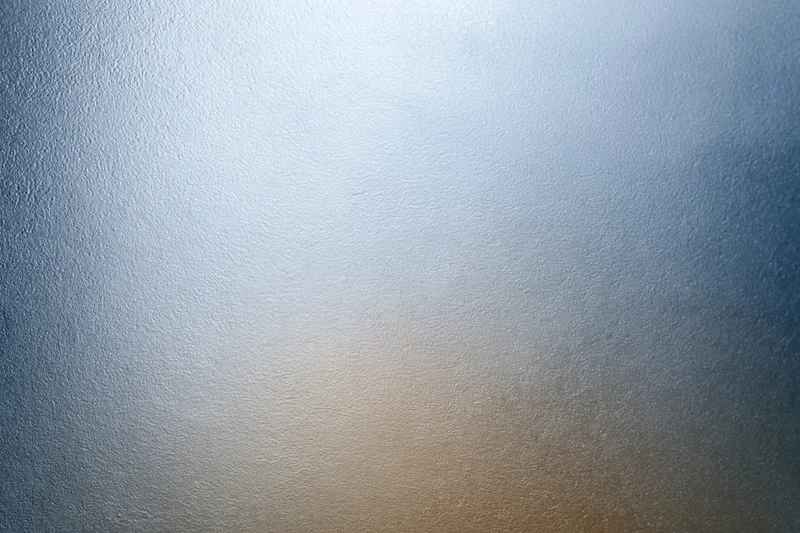Frosted glass surface with smooth texture and light gradient filling the frame