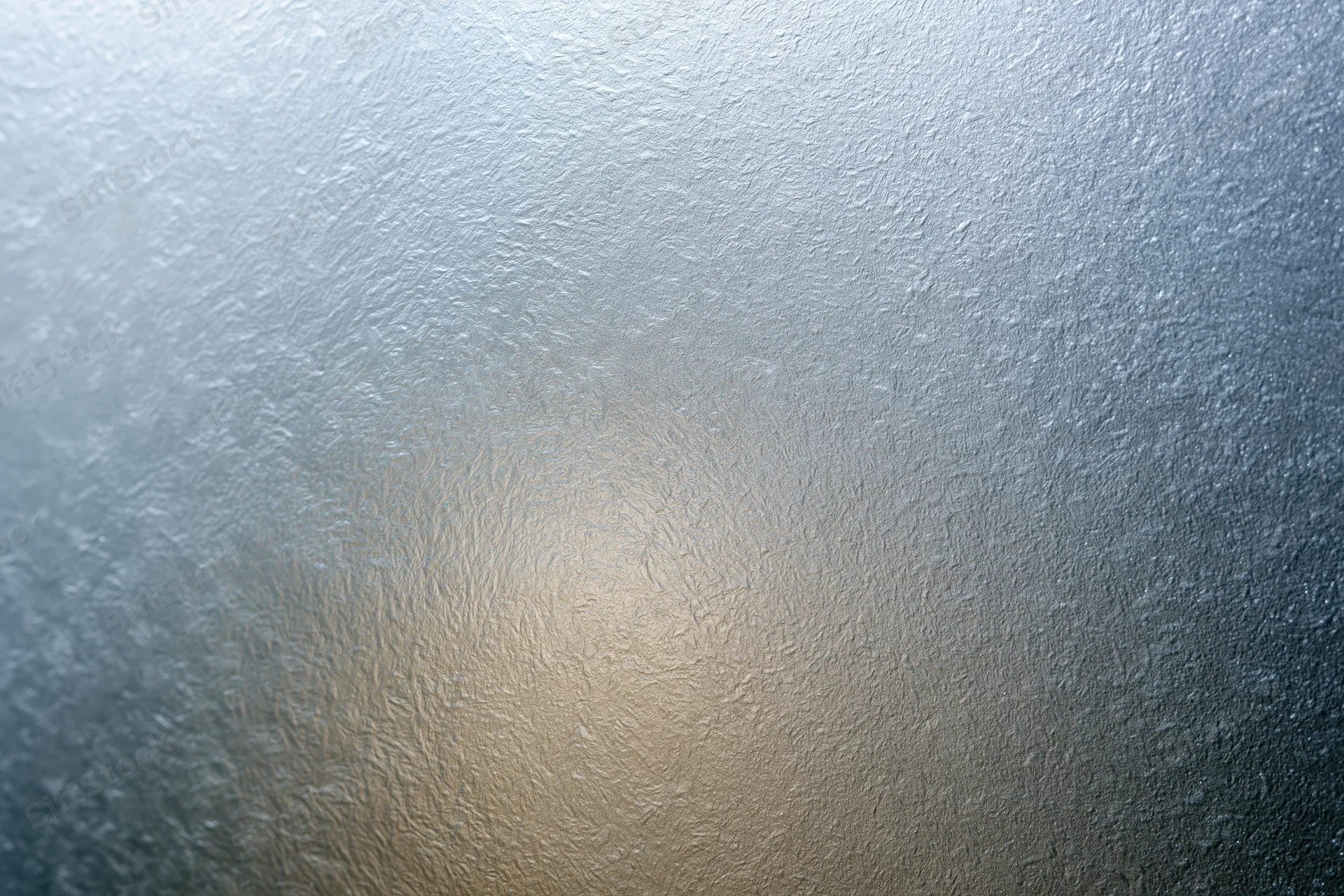 Frosted glass surface with textured pattern and soft light gradient filling the frame