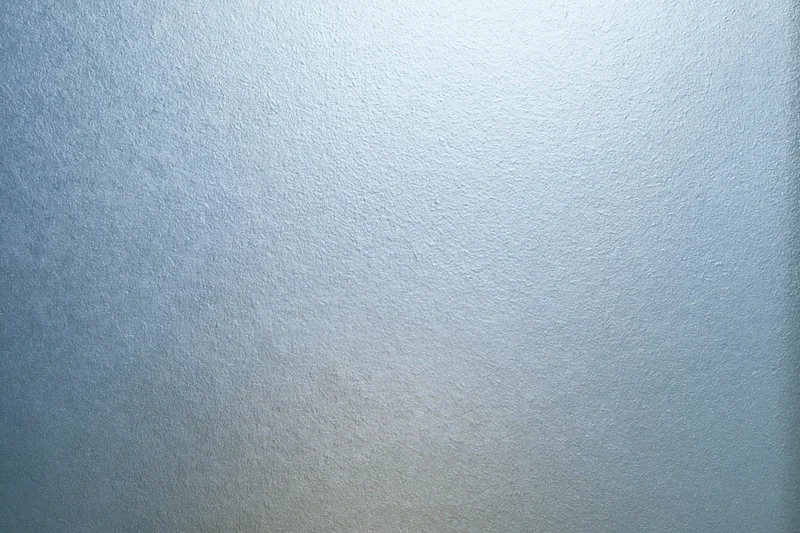 Frosted glass surface with smooth translucent texture filling the frame