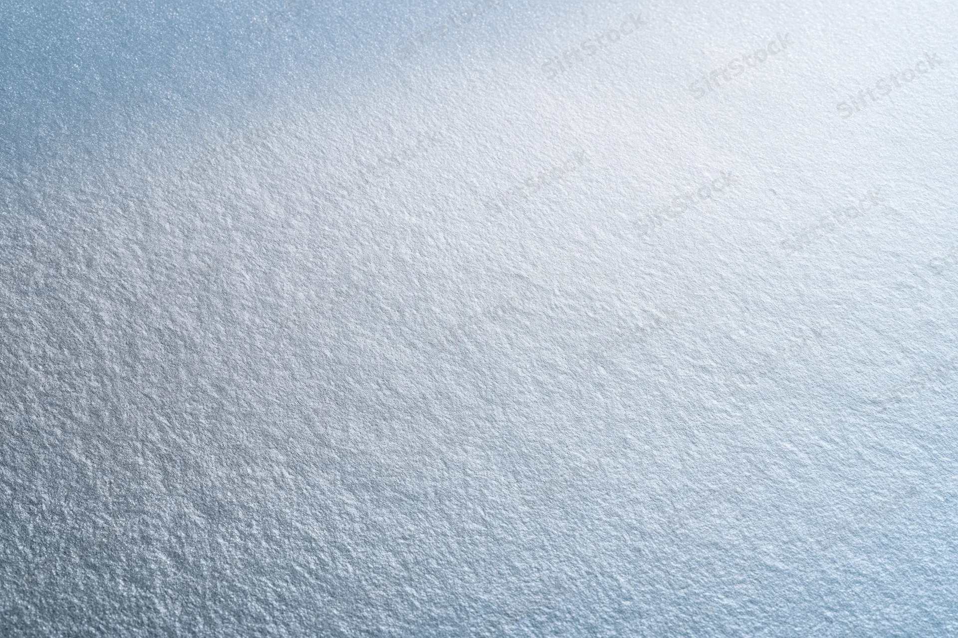 Frosted glass surface in close-up flat lay filling the frame with smooth texture and light gradient