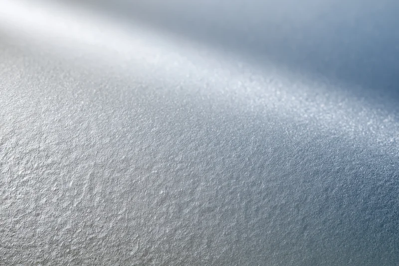 Frosted glass surface in close-up flat lay with soft light and texture details