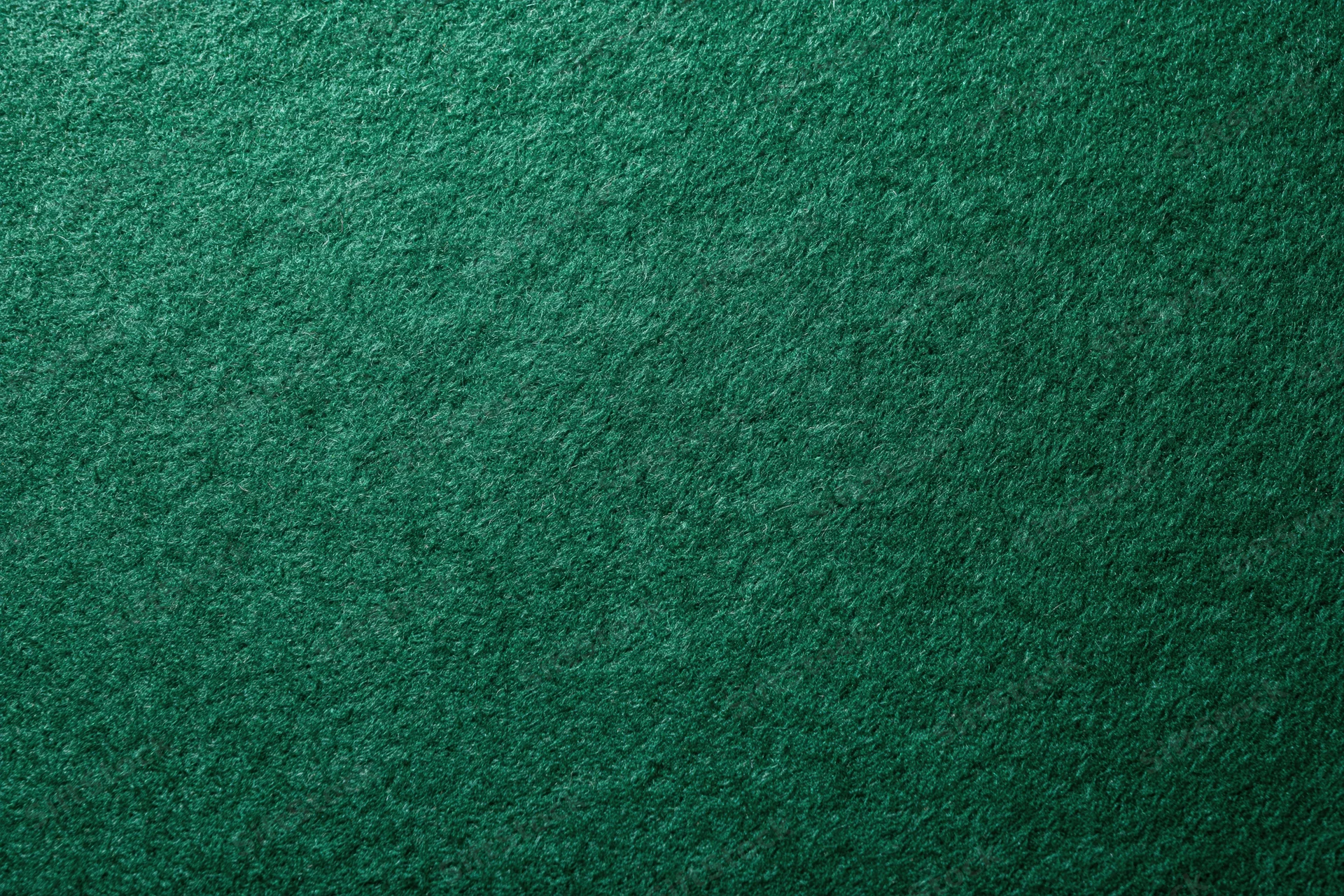 Green casino felt fabric filling the frame in a flat lay close-up view