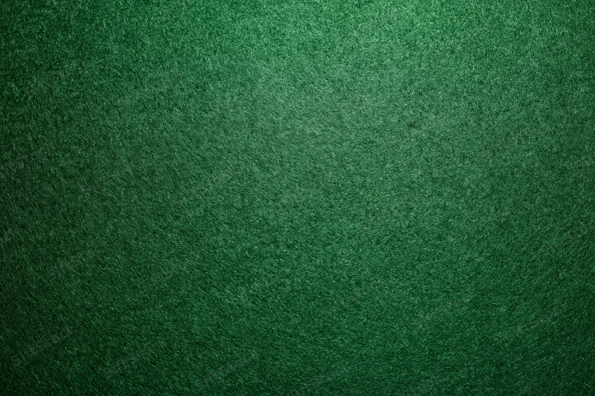 Green casino felt fabric filling the frame in a flat lay close-up view