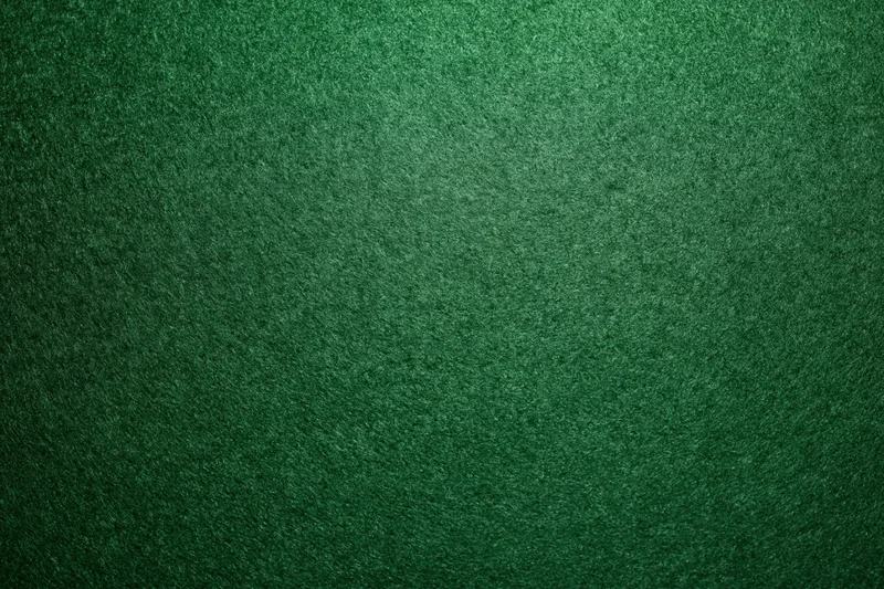Green casino felt fabric filling the frame in a flat lay close-up view