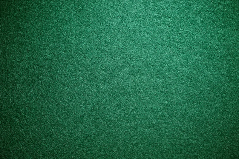 Green casino felt fabric filling the frame in a flat lay close-up view