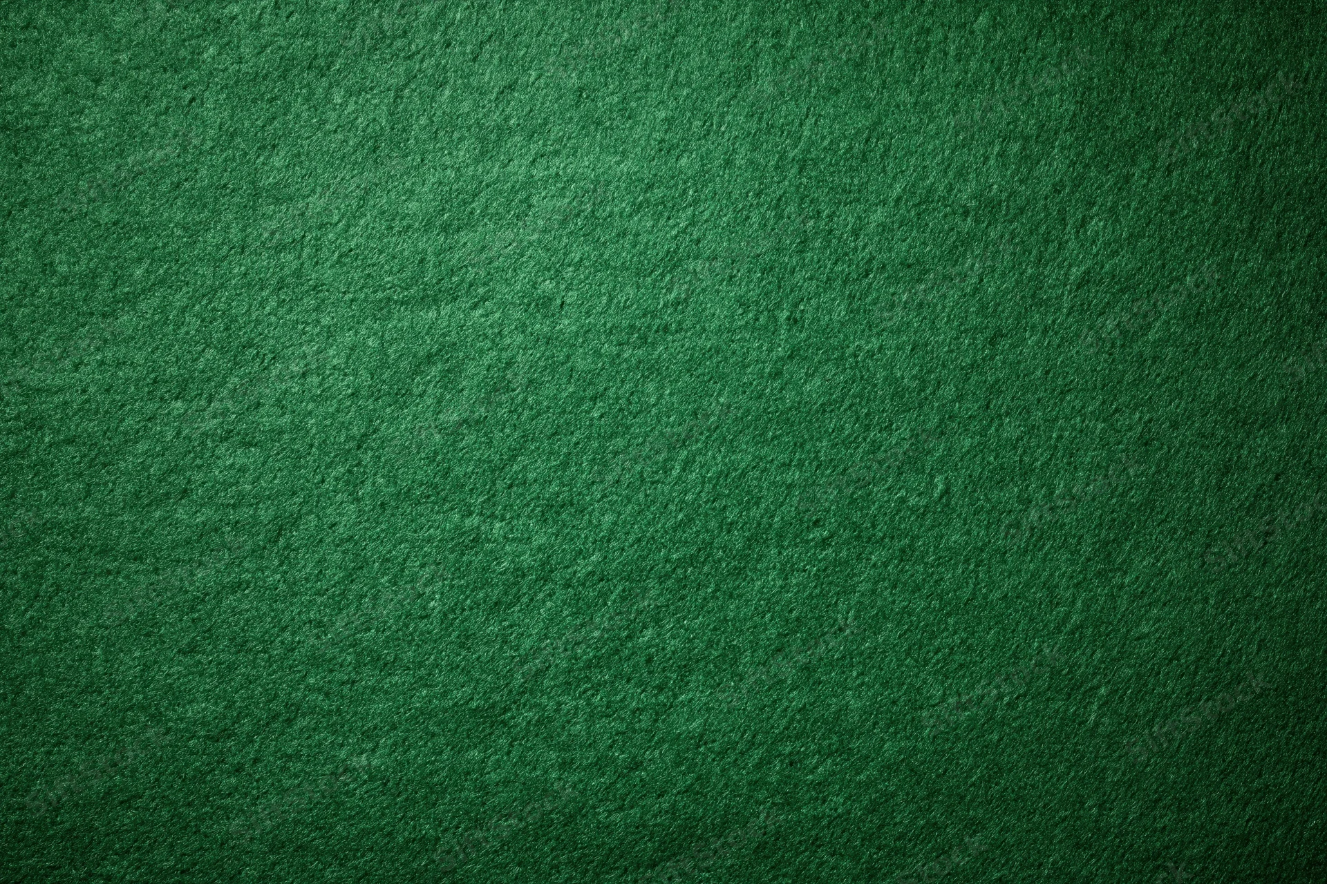 Green casino felt fabric filling the frame in a flat lay close-up view