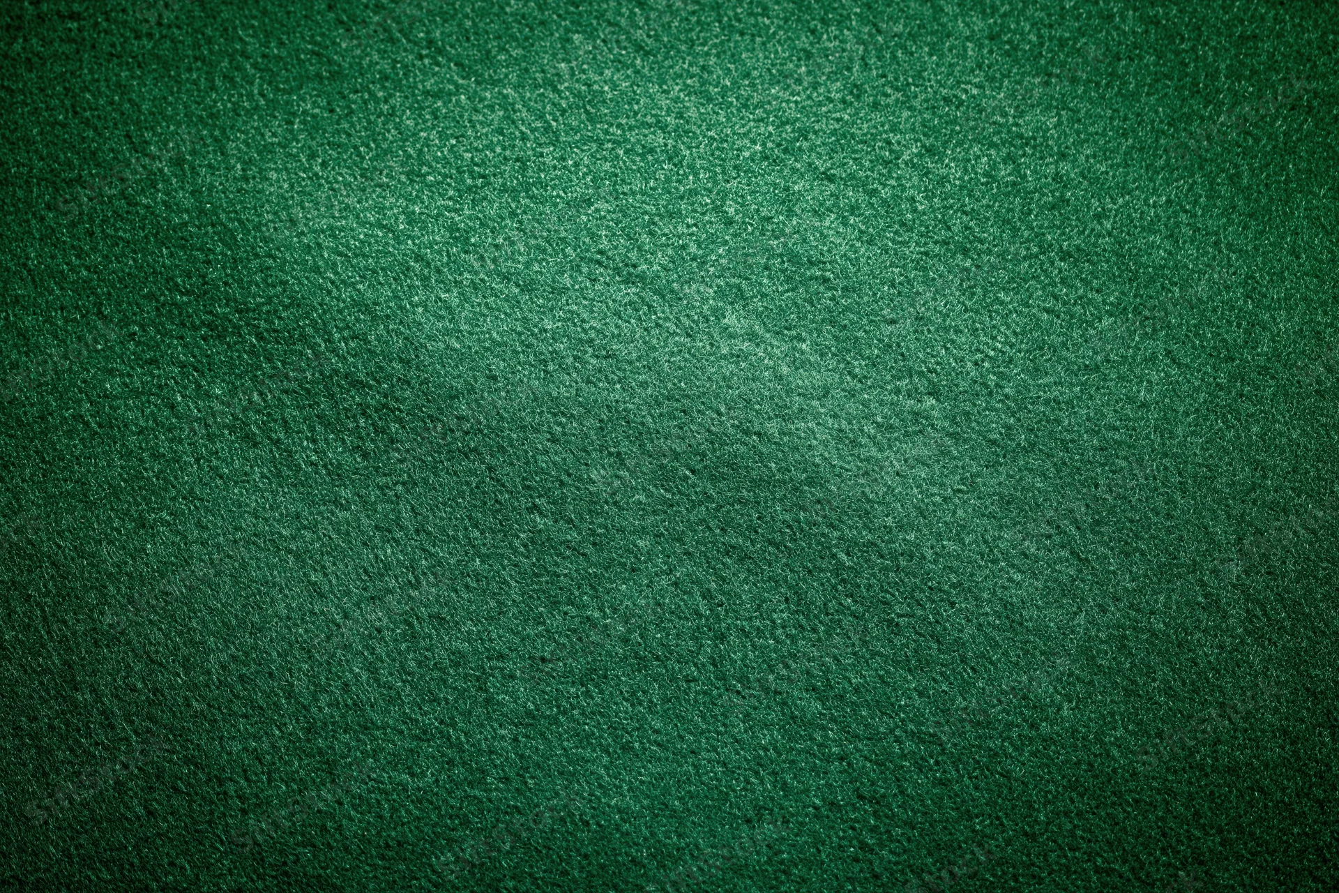 Green casino felt fabric filling the frame in a flat lay close-up view