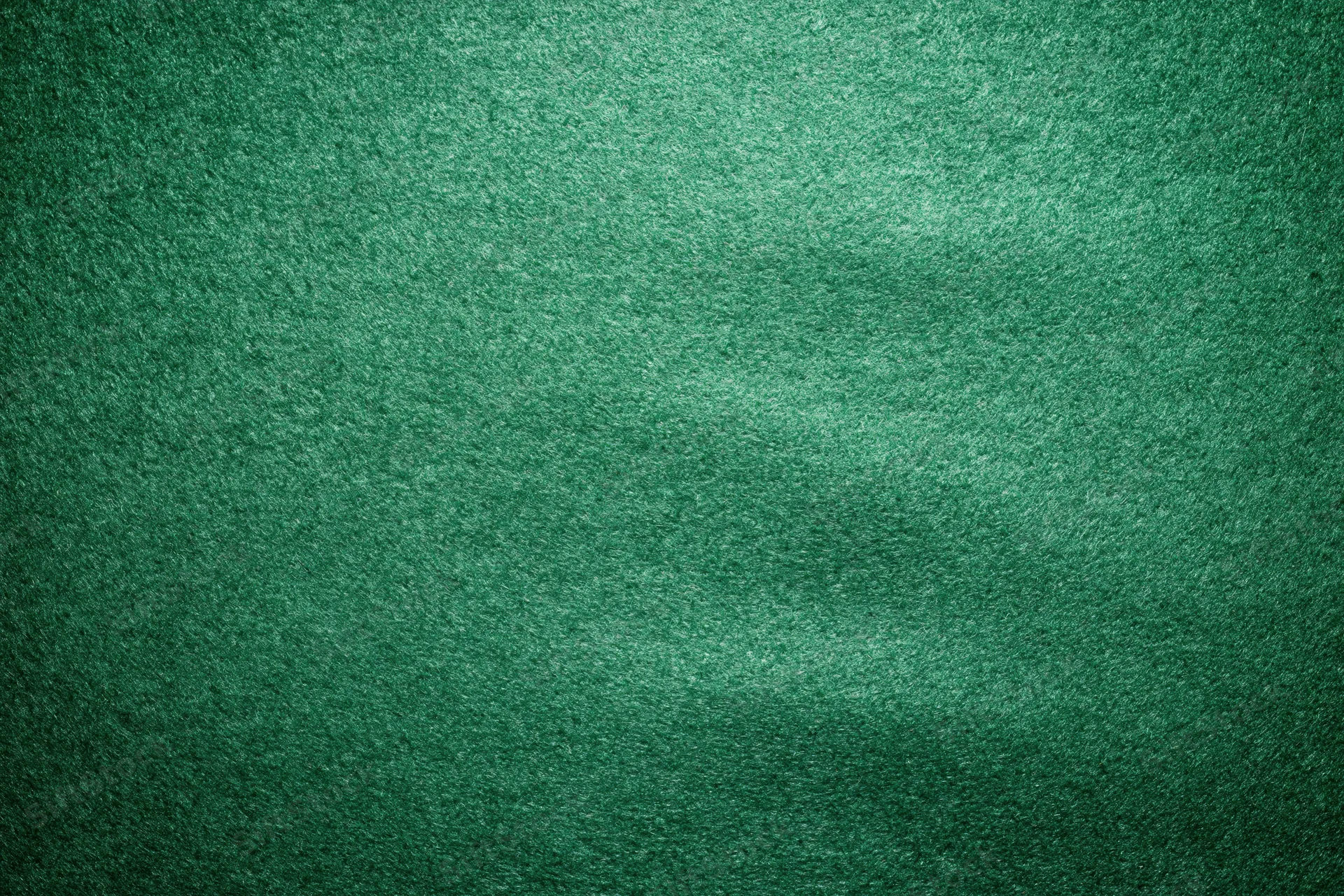 Green casino felt fabric filling the frame in a flat lay close-up view