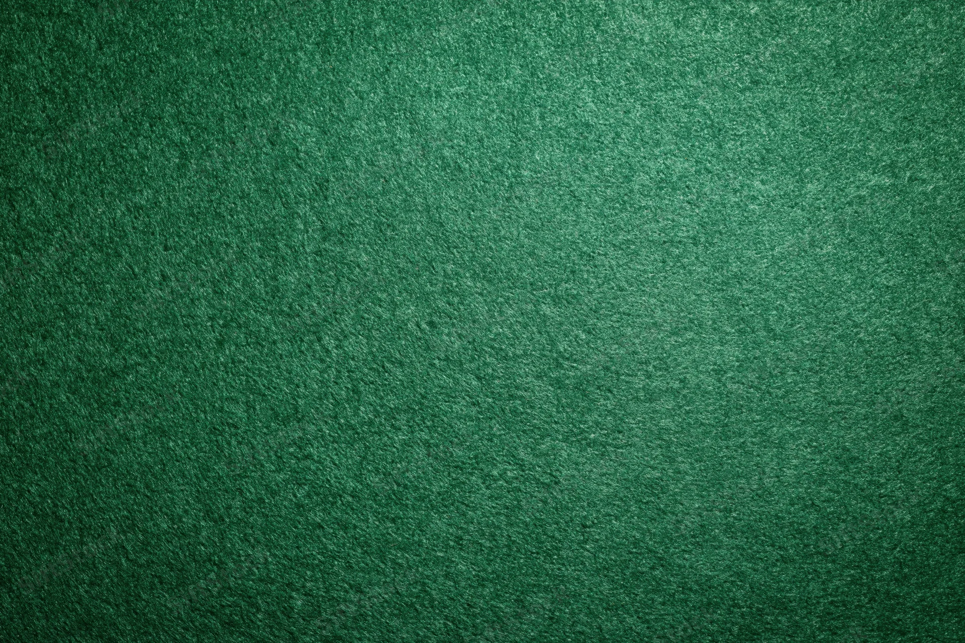 Green casino felt fabric filling the frame in a flat lay close-up view