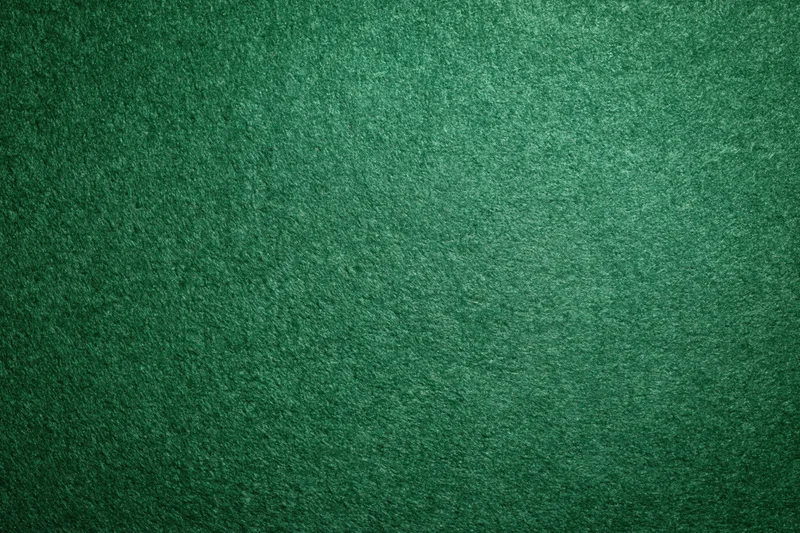Green casino felt fabric filling the frame in a flat lay close-up view