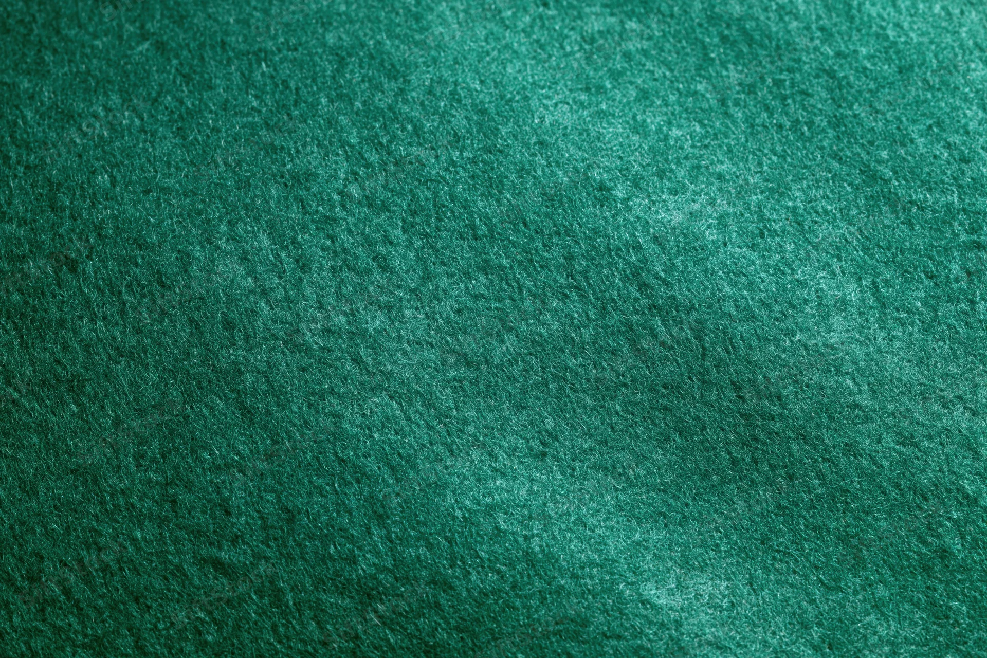 Close-up flat lay of green felt fabric filling the entire frame