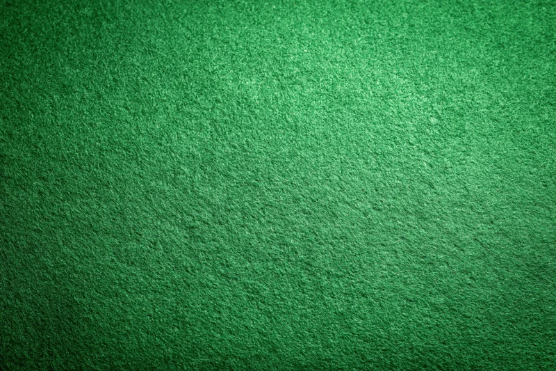Green felt fabric filling the frame in a flat lay close-up view