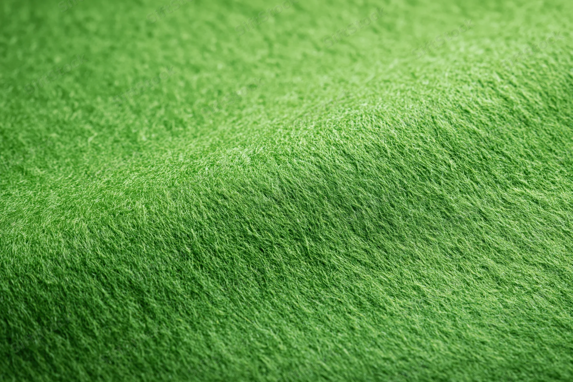 Close-up flat lay of green felt fabric filling the frame
