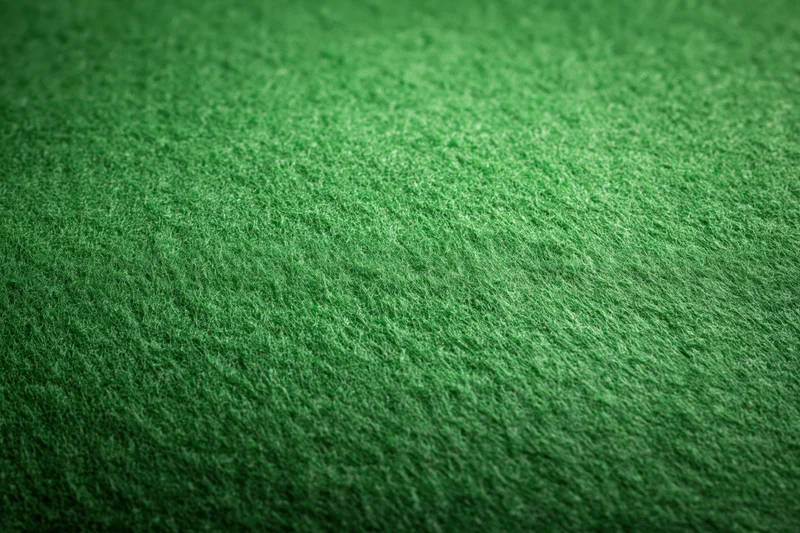 Close-up flat lay of green felt fabric filling the entire frame