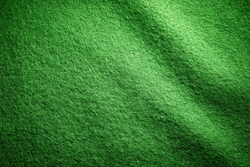 Green felt fabric filling the frame in a flat lay close-up view