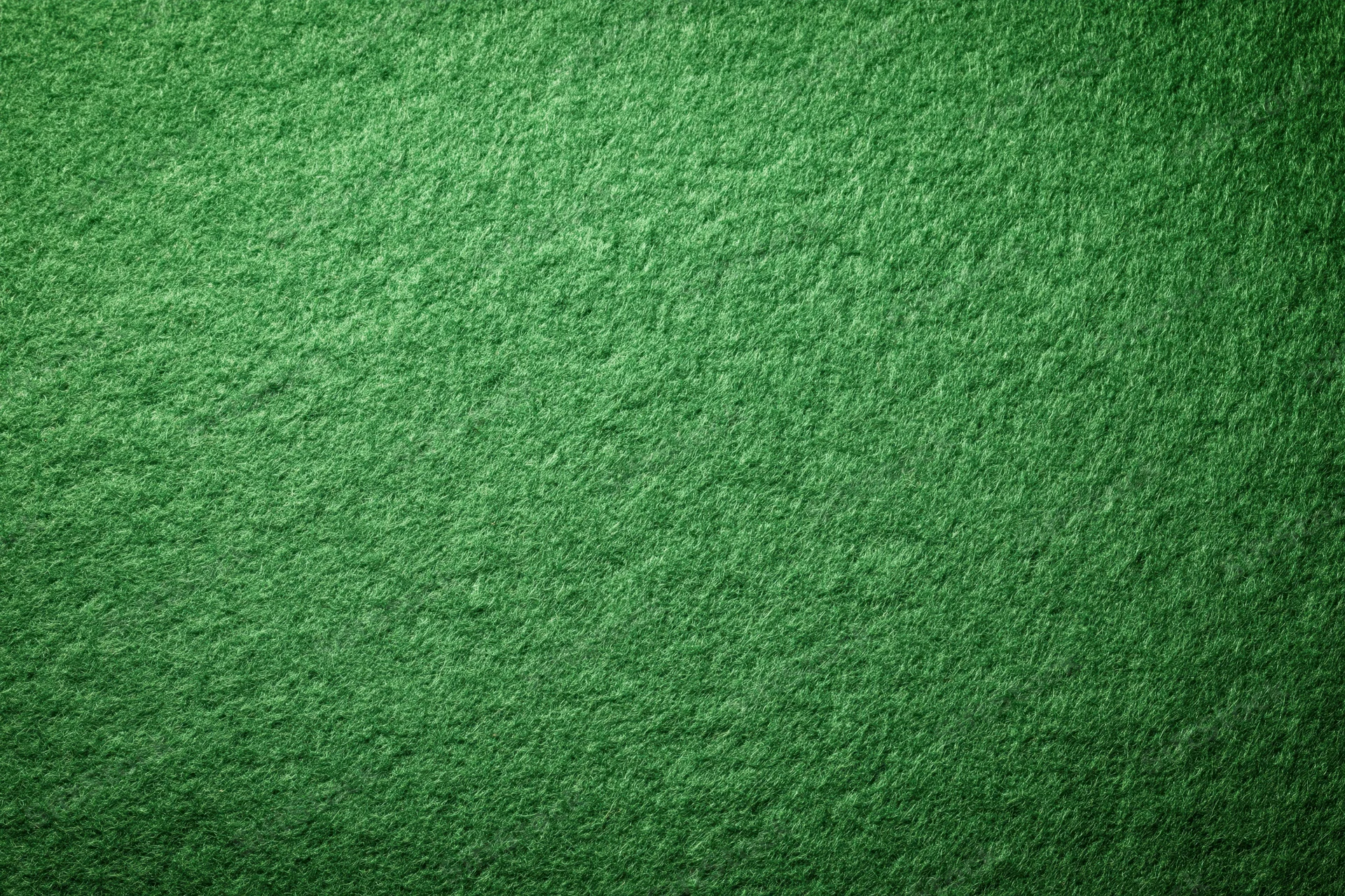 Close-up flat lay of green felt fabric texture filling the frame