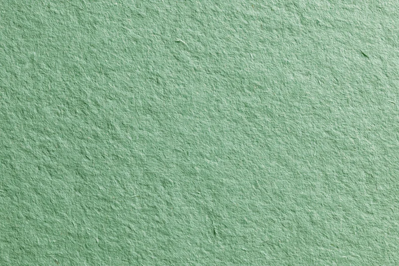 Green recycled cardstock paper filling frame in flat lay closeup