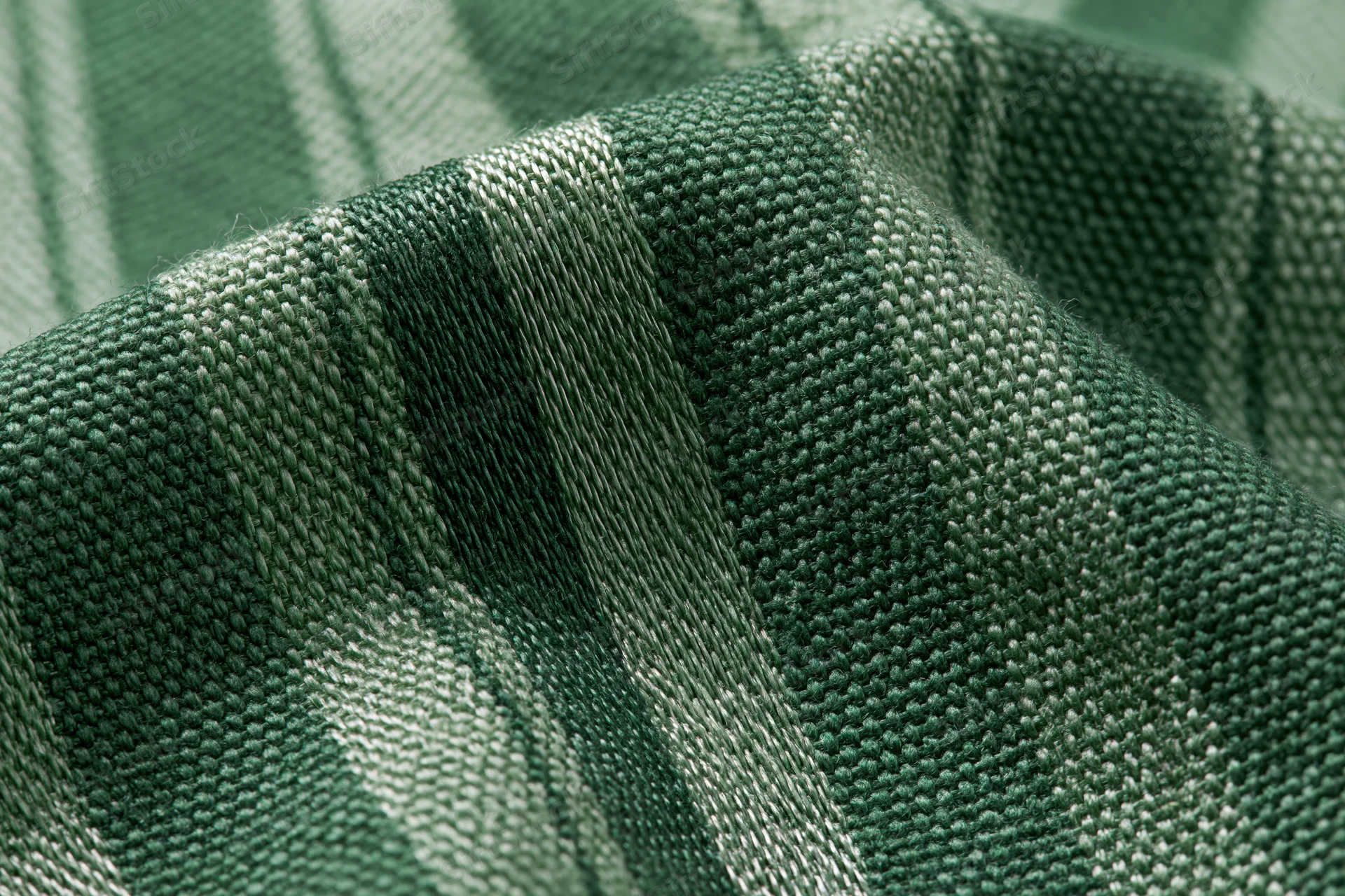 Close-up of green striped woven fabric with checkered pattern filling the frame