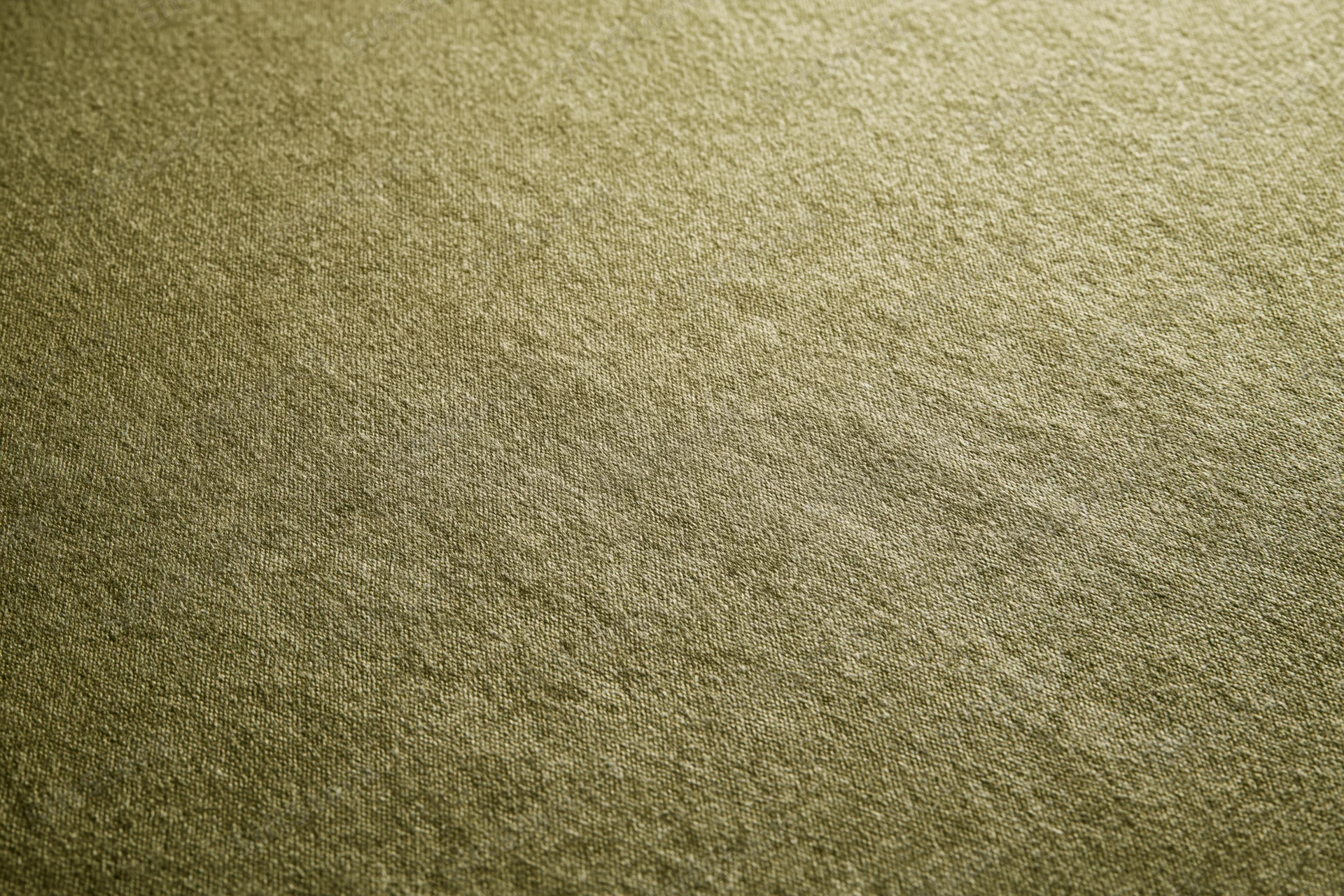 Close-up of medium-green fabric surface filling the frame in a flat lay arrangement