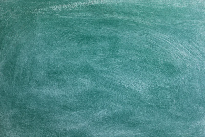 Blank green chalkboard surface with faint white residue and swirl marks, flat close-up view